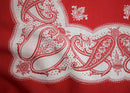 Red and white UFO paisley pattern on a red fabric background