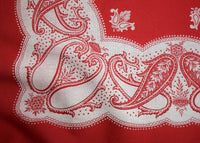 Red and white UFO paisley pattern on a red fabric background